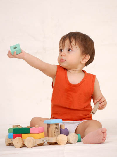 Baby Surrounded By Colorful Toys