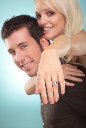 Woman Jumping On Man's Back Showing Off Her New Engagement Ring