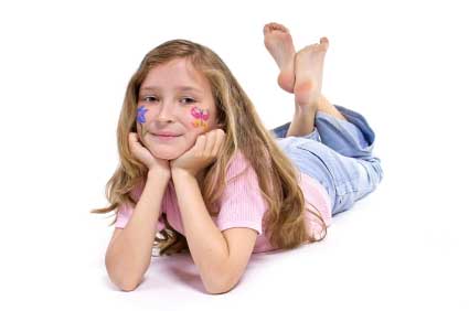 Young Girl Laying On Her Tummy On The Floor