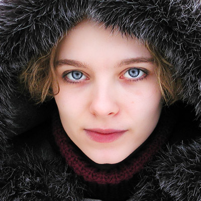 Woman Posing With Furry Hat And Icy Blue Eyes
