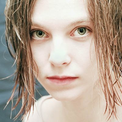 Portrait Pose Of A Young Lady With Wet Look Hair And Green Eyes