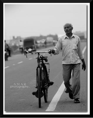 Man Walking With His Bicycle